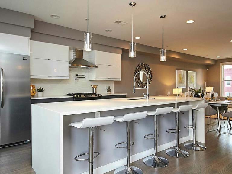 Listed with John Mentis, this Washington, D.C., condo features white quartz countertops.