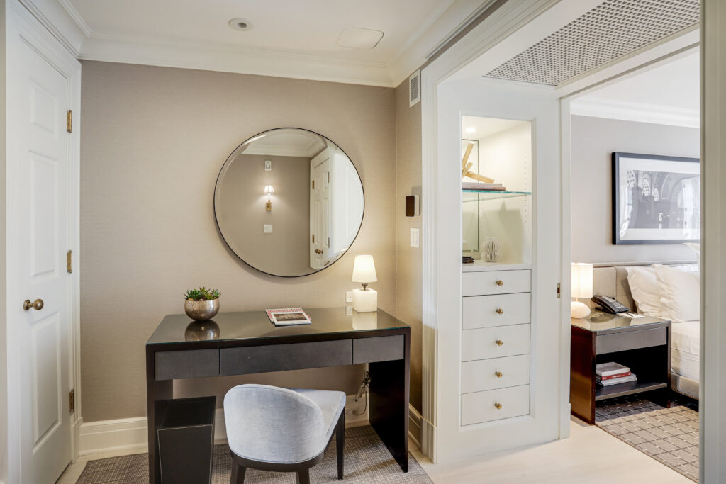 Adjacent to the bedroom, you'll find a private seating area with desk that can be used for work or dressing.
