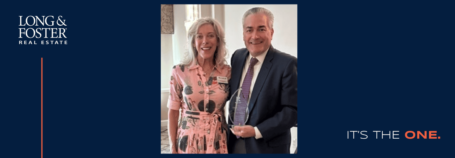 Pictured here, Pam Batstone, president of the Anne Arundel County Association of Realtors' Board, presents Dan Early with the Lifetime Achievement Award.